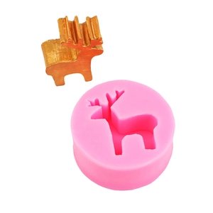 DIY Christmas elk silicone mold for candles and cake decor with a finished gold reindeer