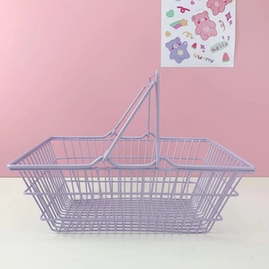 Detail of lavender iron wire storage basket with dual handles for desk organization