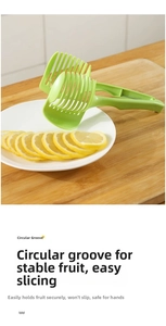 Close-up of green fruit slicer with circular grooves and guide slots for lemon slices
