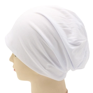Detailed view of white knitted slouchy beanie showing soft fabric texture and ribbed layers