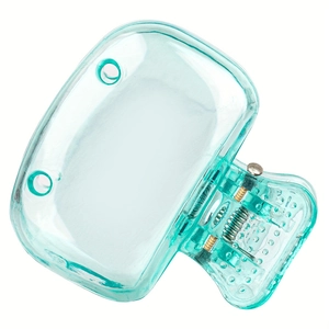 Close-up of translucent mint green travel toothbrush clip with visible metal spring