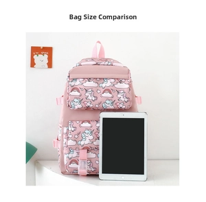 Pink cartoon nylon backpack next to a tablet for size comparison and scale reference