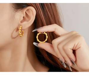 Detail of vintage gold brushed hoops with micro-inlaid cubic zirconia on earlobe