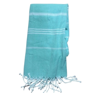 Detail of mint green striped Turkish beach towel with handmade twisted fringe tassels