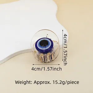 Detail view of a 4cm evil eye hair claw clip made of clear acrylic showing size and weight