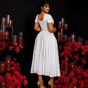 Elegant white V-neck pleated A-line maxi dress for women in a romantic rose garden setting
