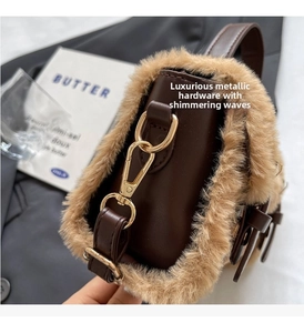 Close-up of luxury brown leather crossbody bag with faux fur trim and gold hardware