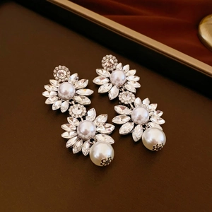 Elegant floral drop earrings with sparkling rhinestones and white faux pearls in silver