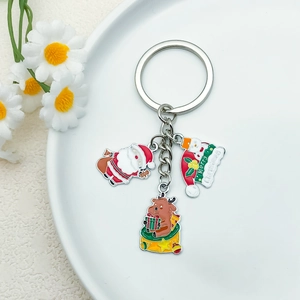 Christmas Santa Snowman Reindeer metal keychain on white plate with daisy decor