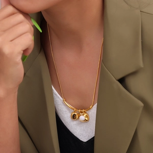 French retro two-tone square pendant necklace in 18k gold-plated steel on a model