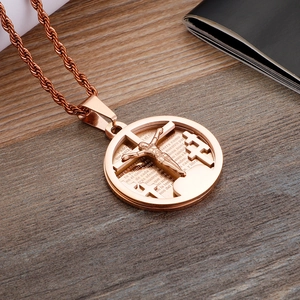 Detailed macro view of rose gold cross pendant with Spanish Lord's Prayer engraving