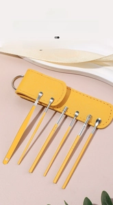 6-piece stainless steel earwax removal kit in a yellow storage case with metal keyring