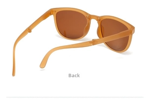 Detail view of foldable amber brown sunglasses with translucent frame and folding temples