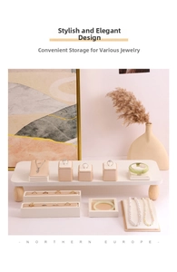 Macro shot of luxury beige PU leather jewelry display set with wooden feet for rings and necklaces