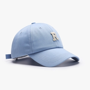 Light blue twill cotton baseball cap featuring a beige towel-embroidered R letter