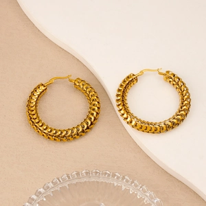 Detailed view of 18K gold-plated stainless steel hoop earrings with woven chain texture