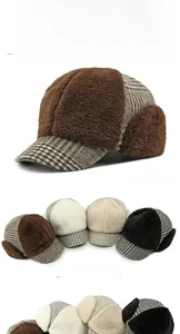 Close-up of thick plush lining and plaid fabric on a warm winter earflap baseball cap