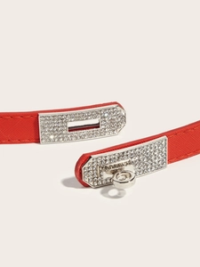 Detail of red Saffiano leather belt with silver pavé rhinestone Kelly buckle
