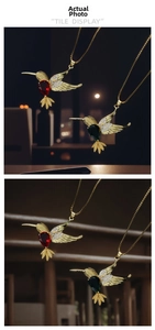 Detail of hummingbird necklace with zircon wings and red or green pear-cut gemstones