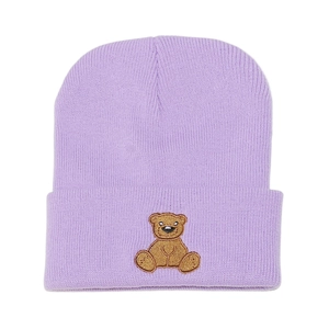 Detailed close-up of brown bear embroidery on a lavender ribbed knit beanie hat