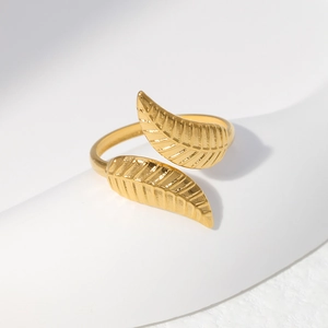 Macro detail of golden leaf ring with intricate textures on adjustable open band