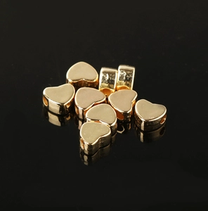 Macro-opname van gouden hartvormige metalen kralen voor DIY-sieraden en kettingen