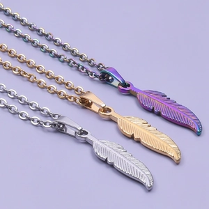 Three minimalist stainless steel feather pendant necklaces in silver, gold and rainbow finish
