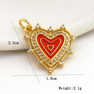 Macro detail of red enamel heart pendant with sparkling rhinestones and size measurements