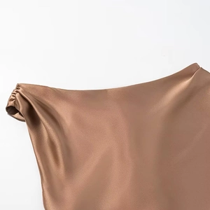 Detail of coffee brown satin dress neckline showing luxurious glossy fabric and draping