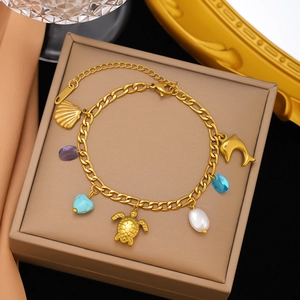 Gold stainless steel ocean bracelet with sea turtle, dolphin and turquoise charms