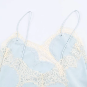 Detailed close-up of light blue satin slip dress with exquisite floral lace trim