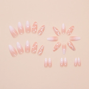 Pink and white gradient press-on nails with heart patterns and wavy line almond shapes