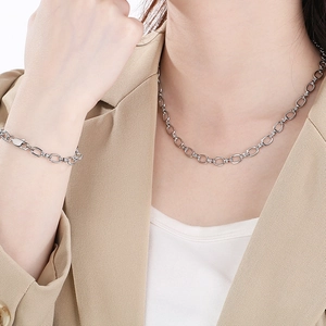 Ensemble collier et bracelet en acier inoxydable poli porté par un mannequin
