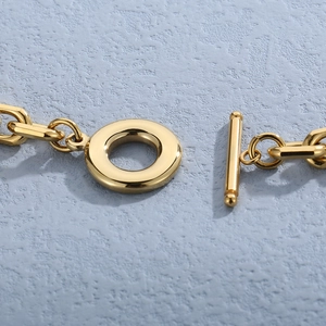 Navy style jewelry set with gold toggle clasp and polished anchor pendant link details