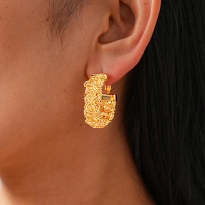 Detailed view of 24k gold plated geometric earrings with intricate woven texture finish