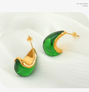 Detail of 18K gold-plated waterdrop earrings featuring emerald green resin texture