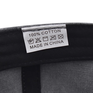 Close-up of internal wash label showing 100% cotton material on the short brim cap