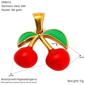 Detail view of red cherry pendant in 18k gold plated steel with 20mm width and 18mm height