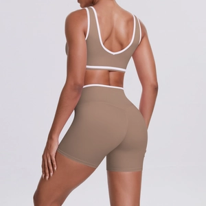 Back view of taupe yoga set with white piping on sports bra and high waist shorts