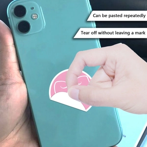 Detail showing pink bow stickers being peeled off a phone without leaving any marks