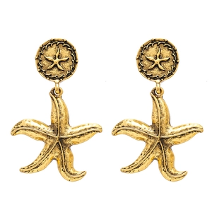 Retro golden starfish drop earrings with vintage metallic texture on a white background