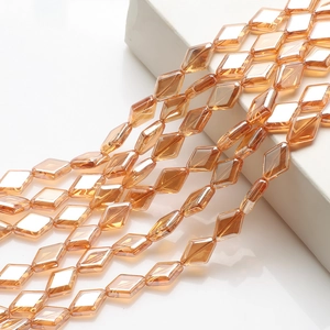 Macro view of amber diamond-cut glass crystal beads with electroplated luster