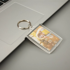 Clear acrylic photo keychain with silver metal ring on laptop, 3.5x4.5cm frame size