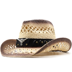 Detail of hand-woven straw cowboy hat with metallic bull head emblem and leather trim