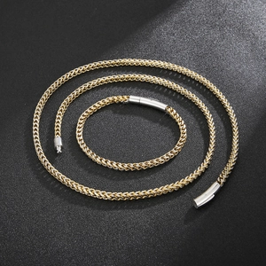 Detail of two-tone gold and silver wheat chain set with cylindrical magnetic clasps