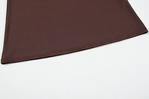 Detail view of smooth dark brown knit fabric hem with professional double-needle stitching
