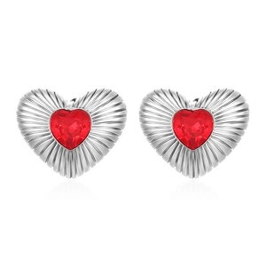 Elegant heart-shaped silver earrings featuring centered red crystal on white background
