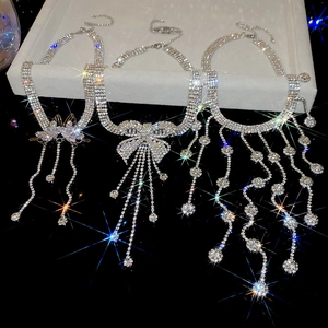 Detailed close-up of three luxury silver necklaces with cubic zirconia fringe tassels