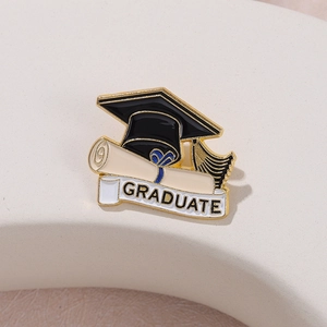 Enamel graduation cap and diploma brooch with Graduate banner in elegant metal finish