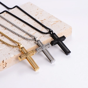 Three minimalist stainless steel cross necklaces in gold silver and black with spiral texture